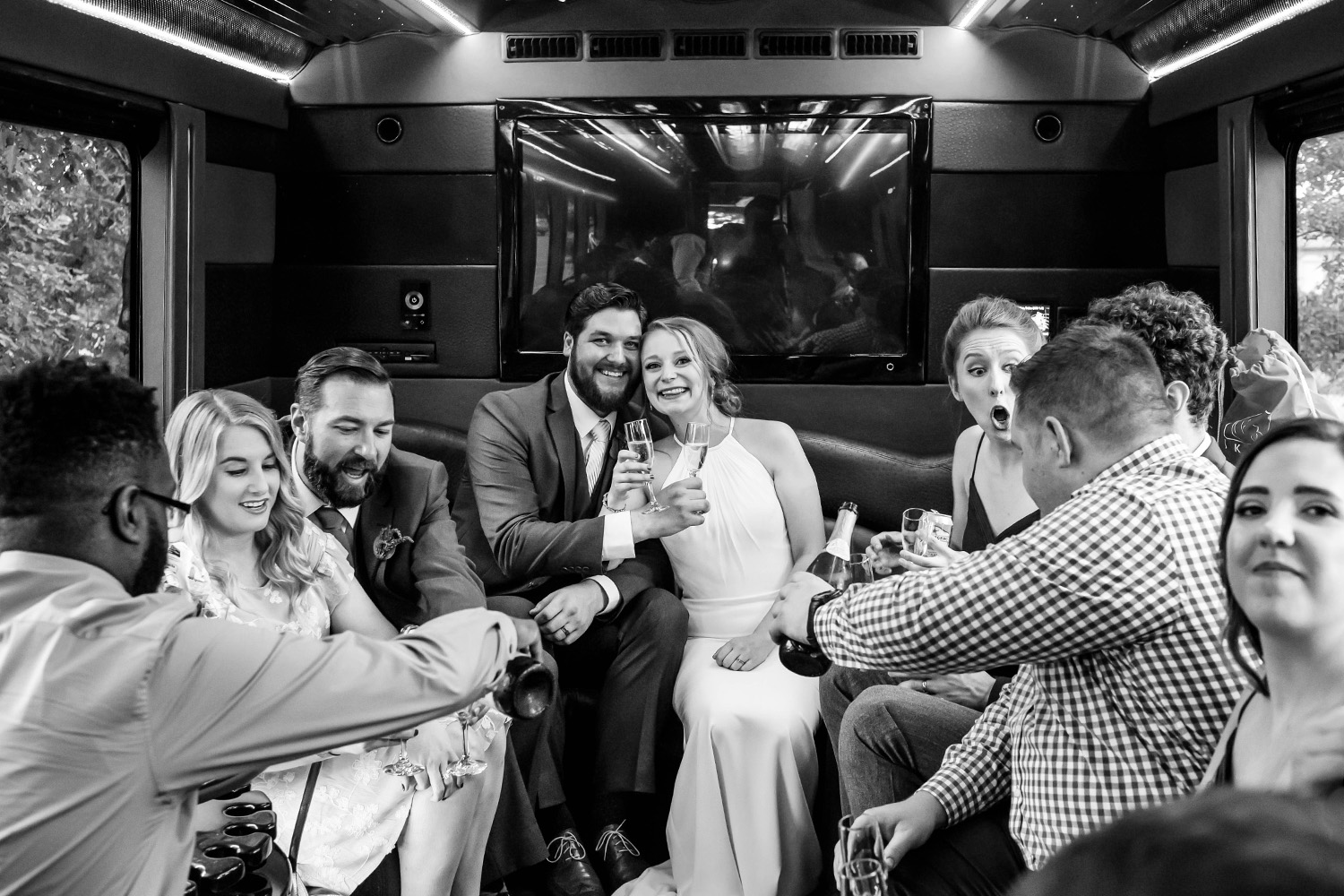 wedding party in the limo on the way to the reception