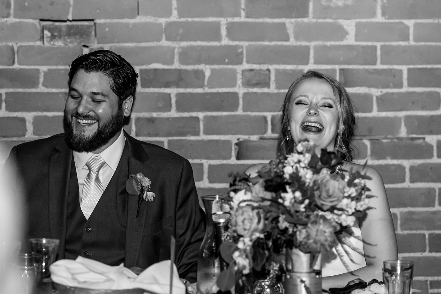 bride and groom laughing during their speeches