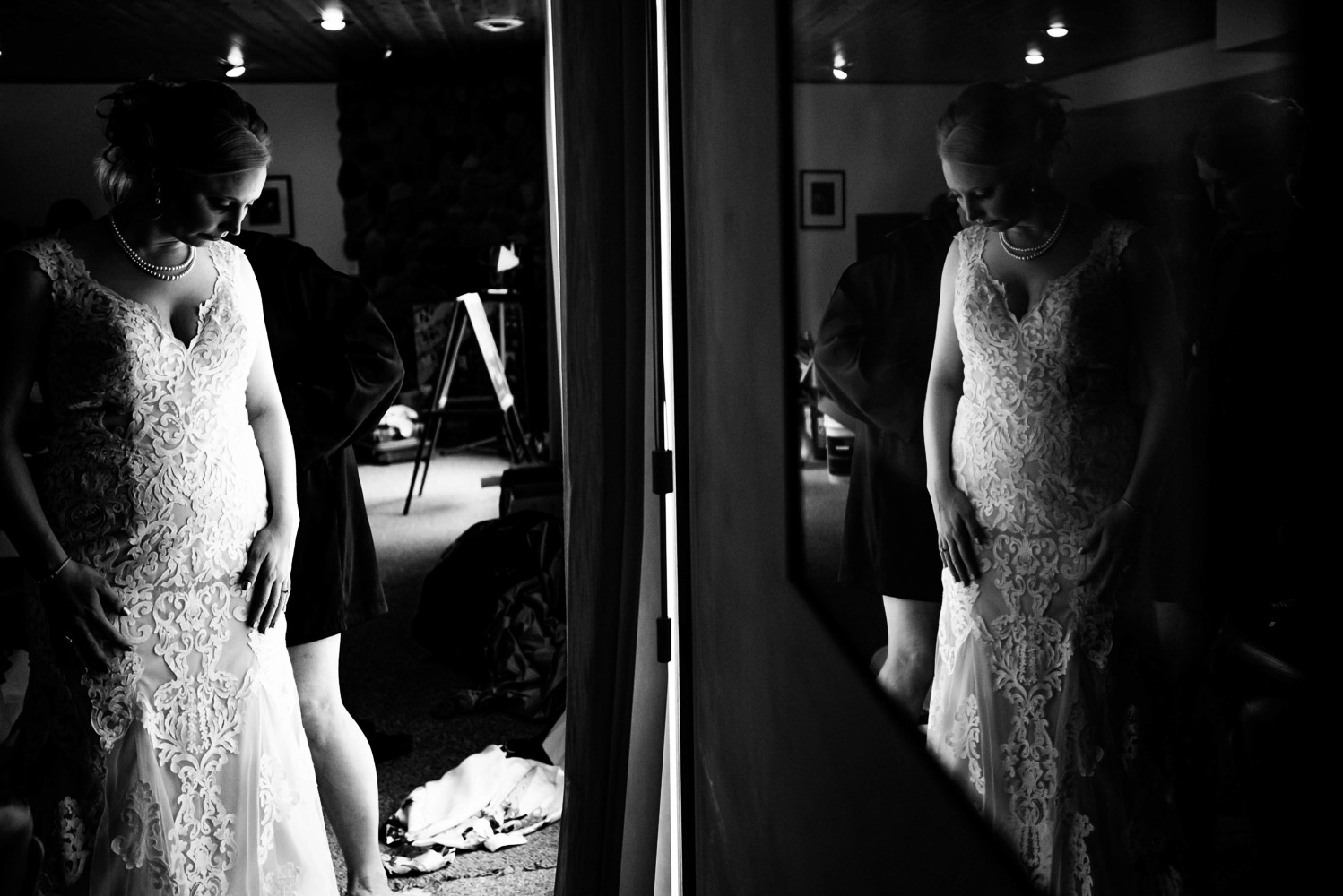 bride in her wedding dress reflected in a window