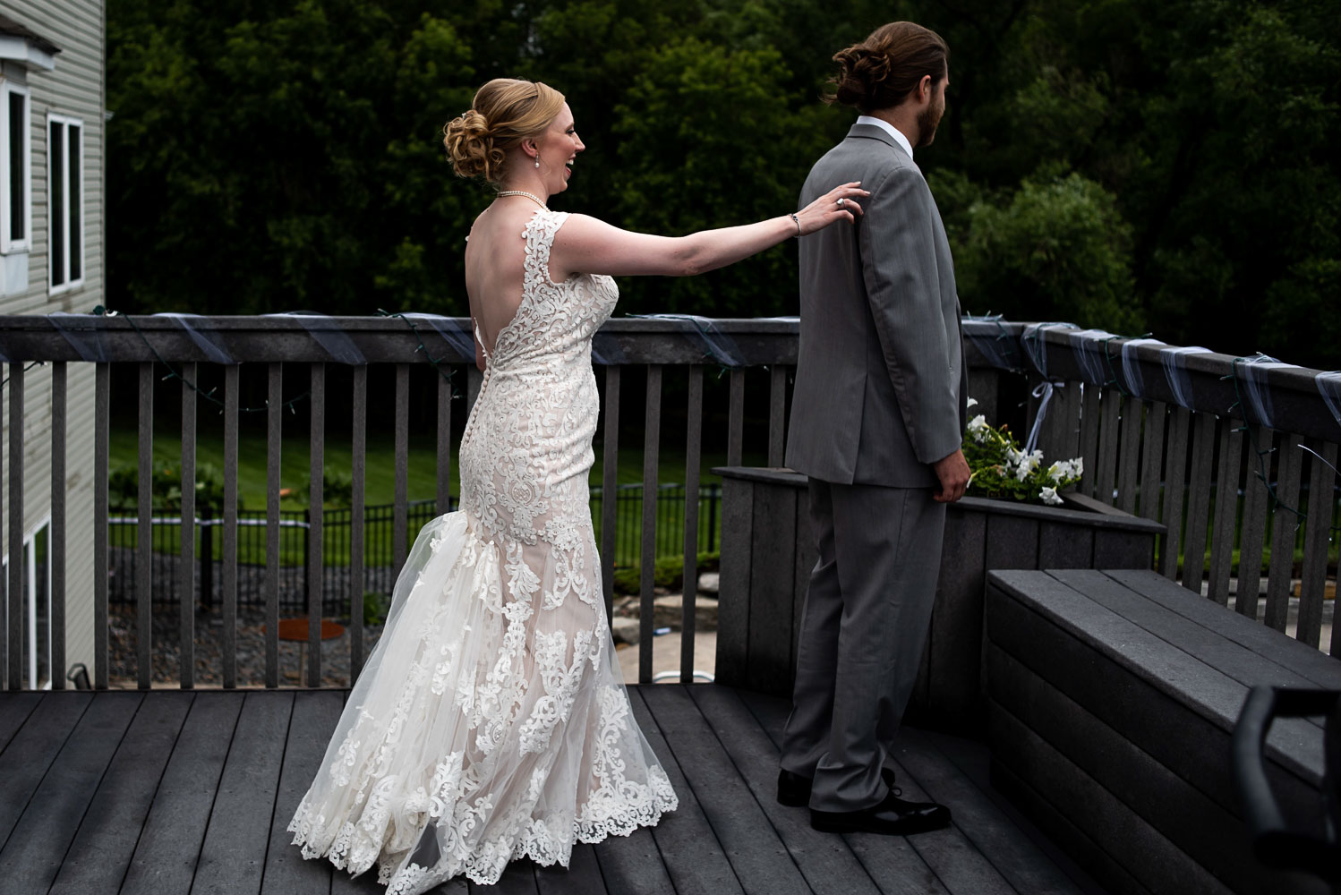 bride tapping the groom on the shoulder before their first look