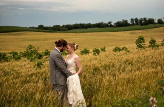 bride and groom hugging in a field in Minnesota