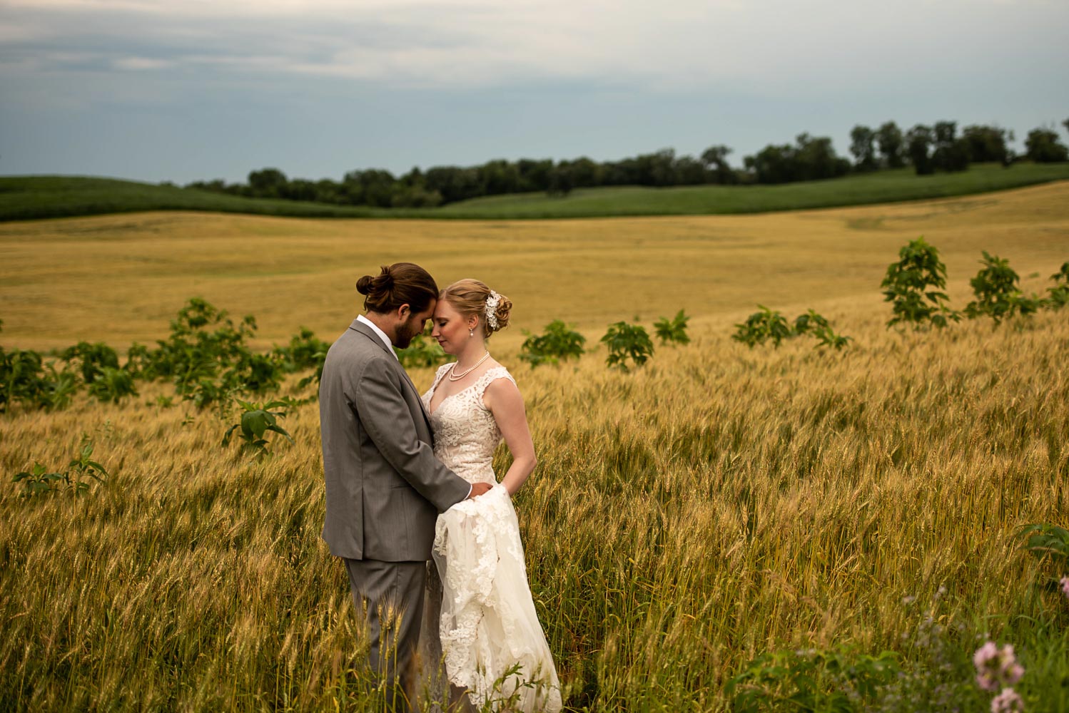 bride and groom hugging in a field in Minnesota