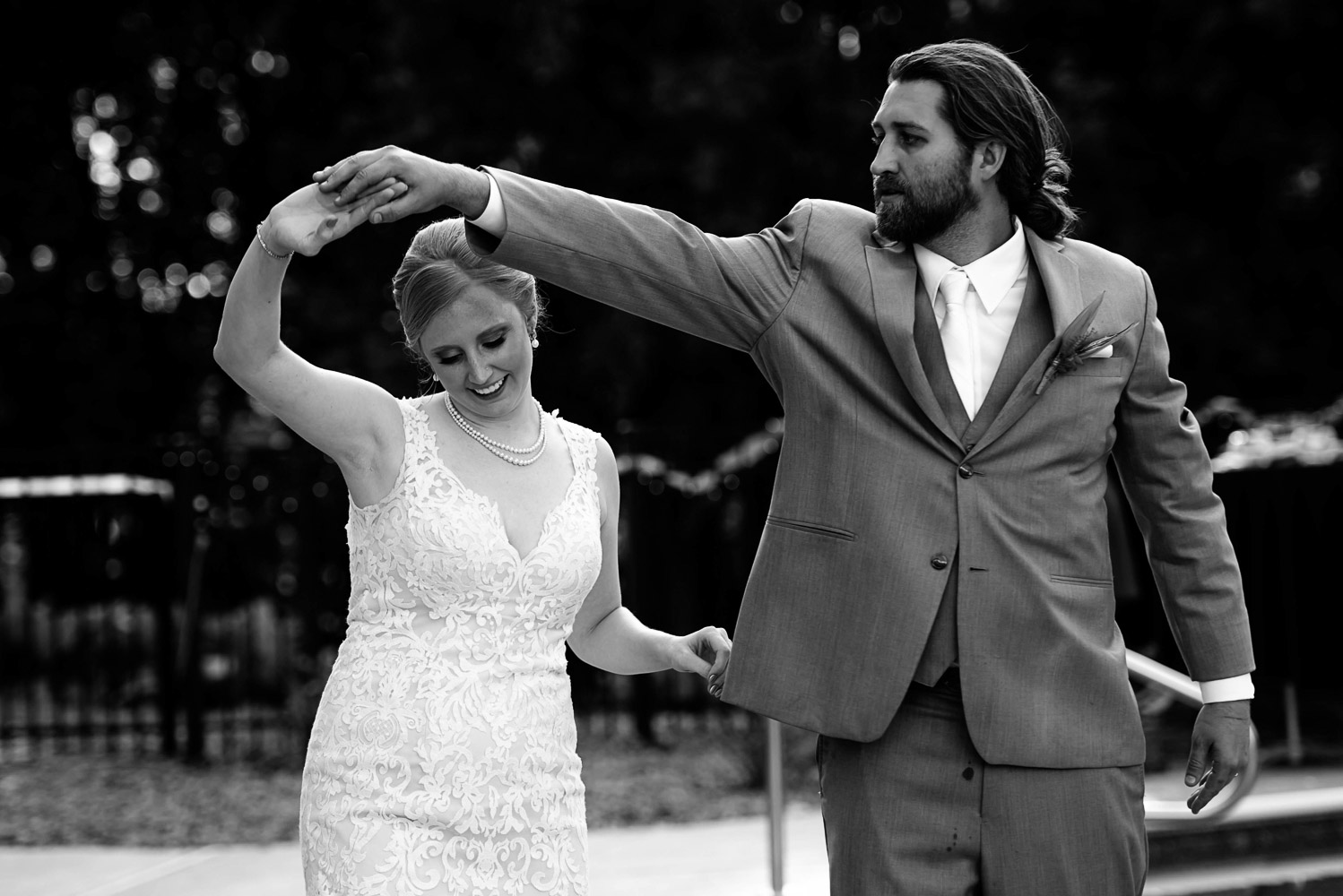 bride and groom first dance twirling at their summer wedding