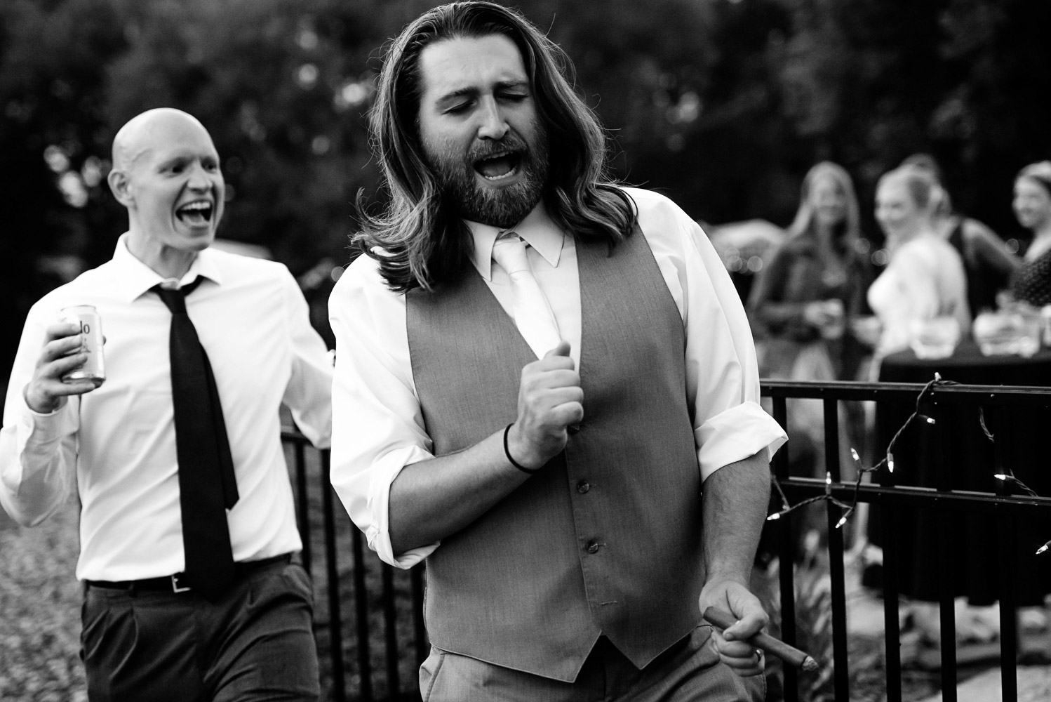 groom dancing with the wedding guests at their backyard summer wedding
