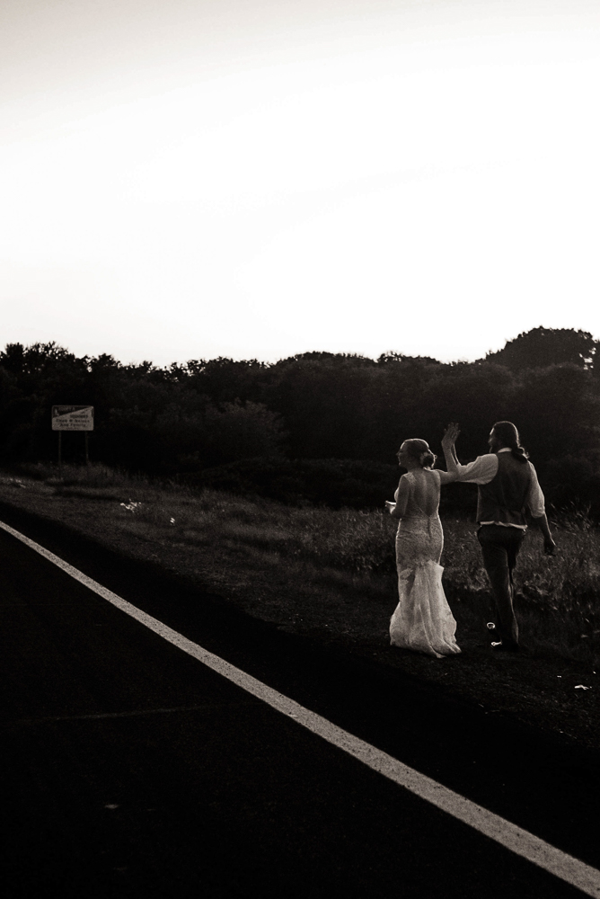 bride and groom walking down the road on their wedding day in Minnesota
