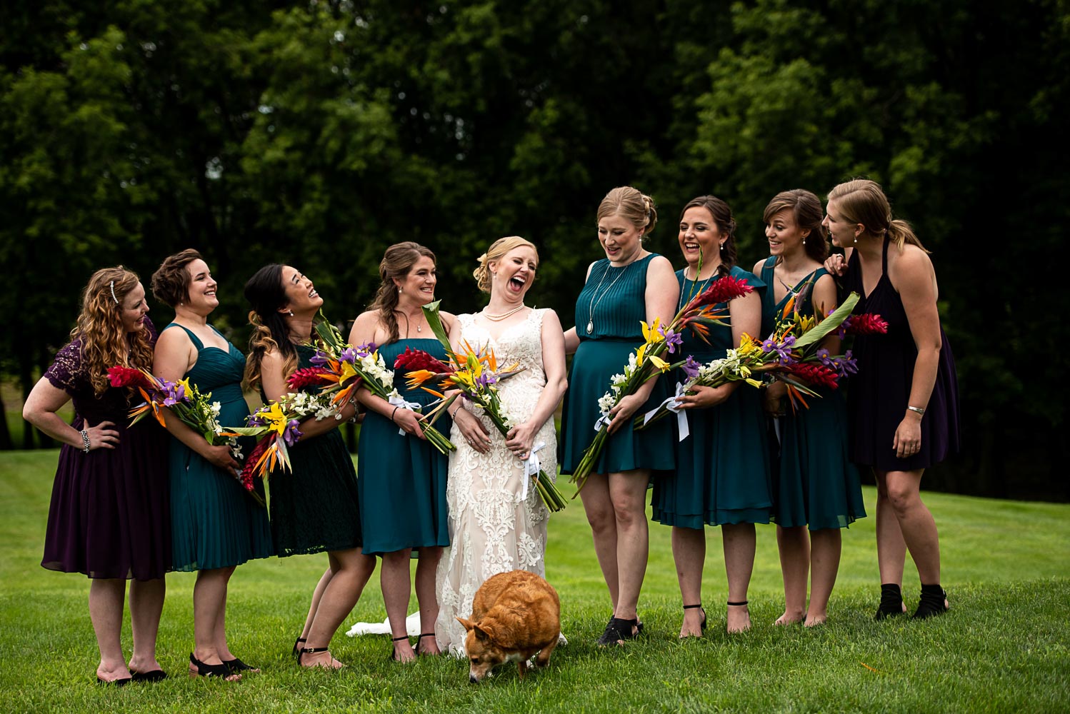 bride and bridesmaids laughing during together during the summer backyard wedding