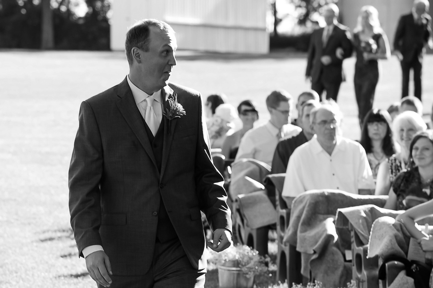 groom walking down the aisle for his Iowa farm wedding