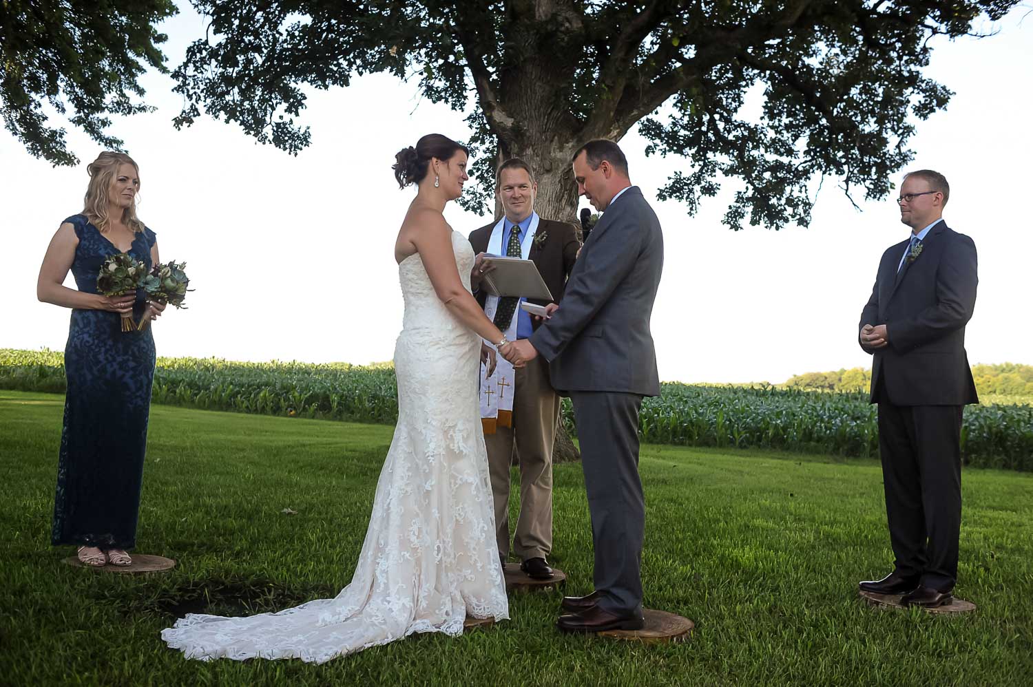 bride and groom exchanging vows at theirIowa farm wedding ceremony