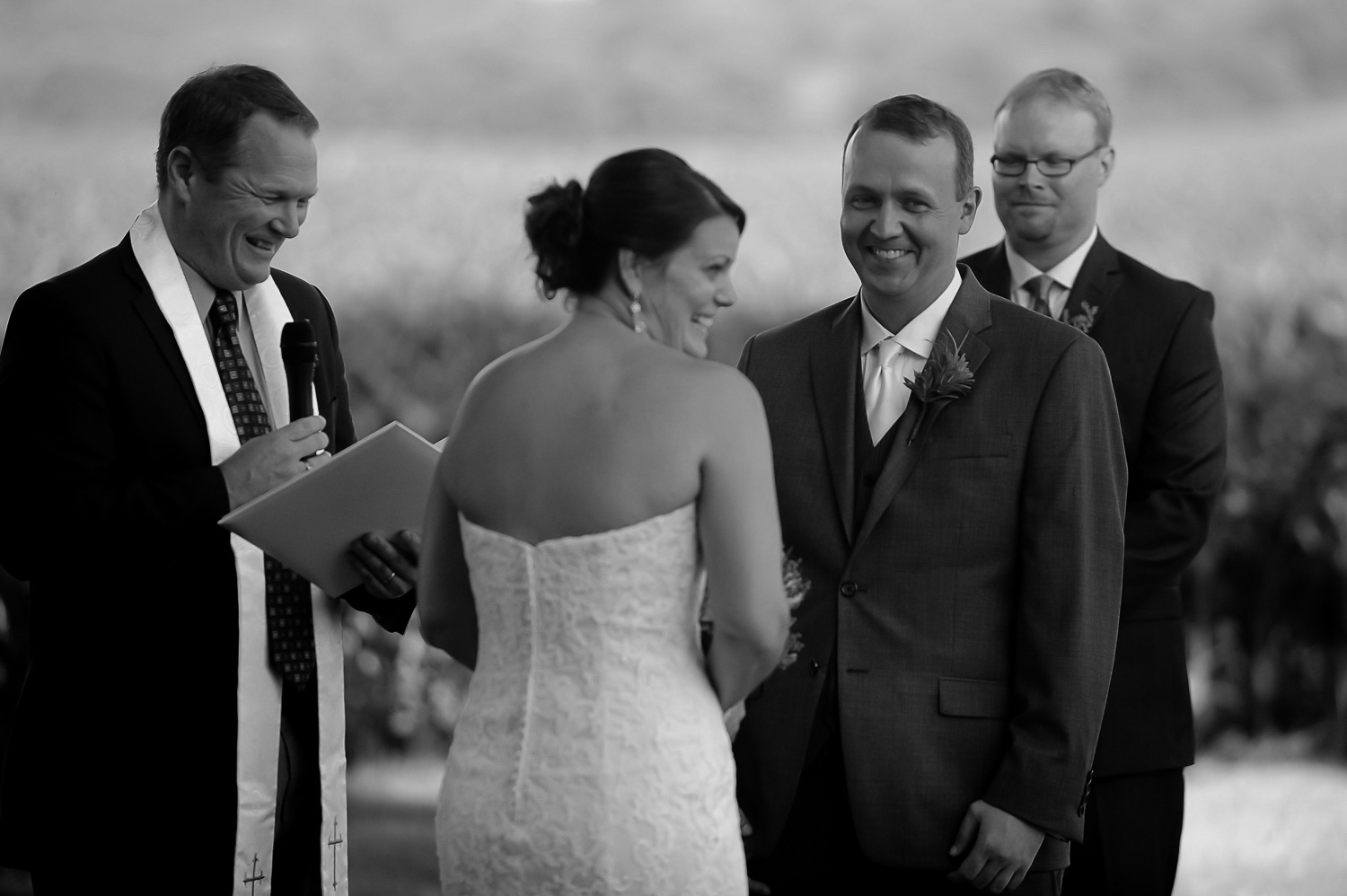 bride and groom laughing during their ceremony at their Iowa Farm wedding