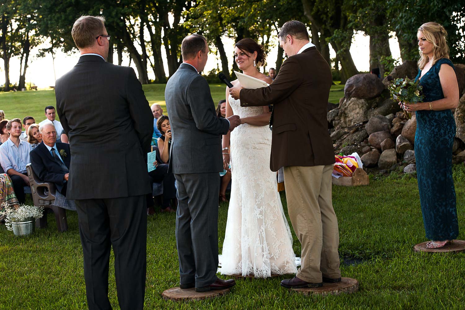 bride and groom laughing during their ceremony at their Iowa Farm wedding