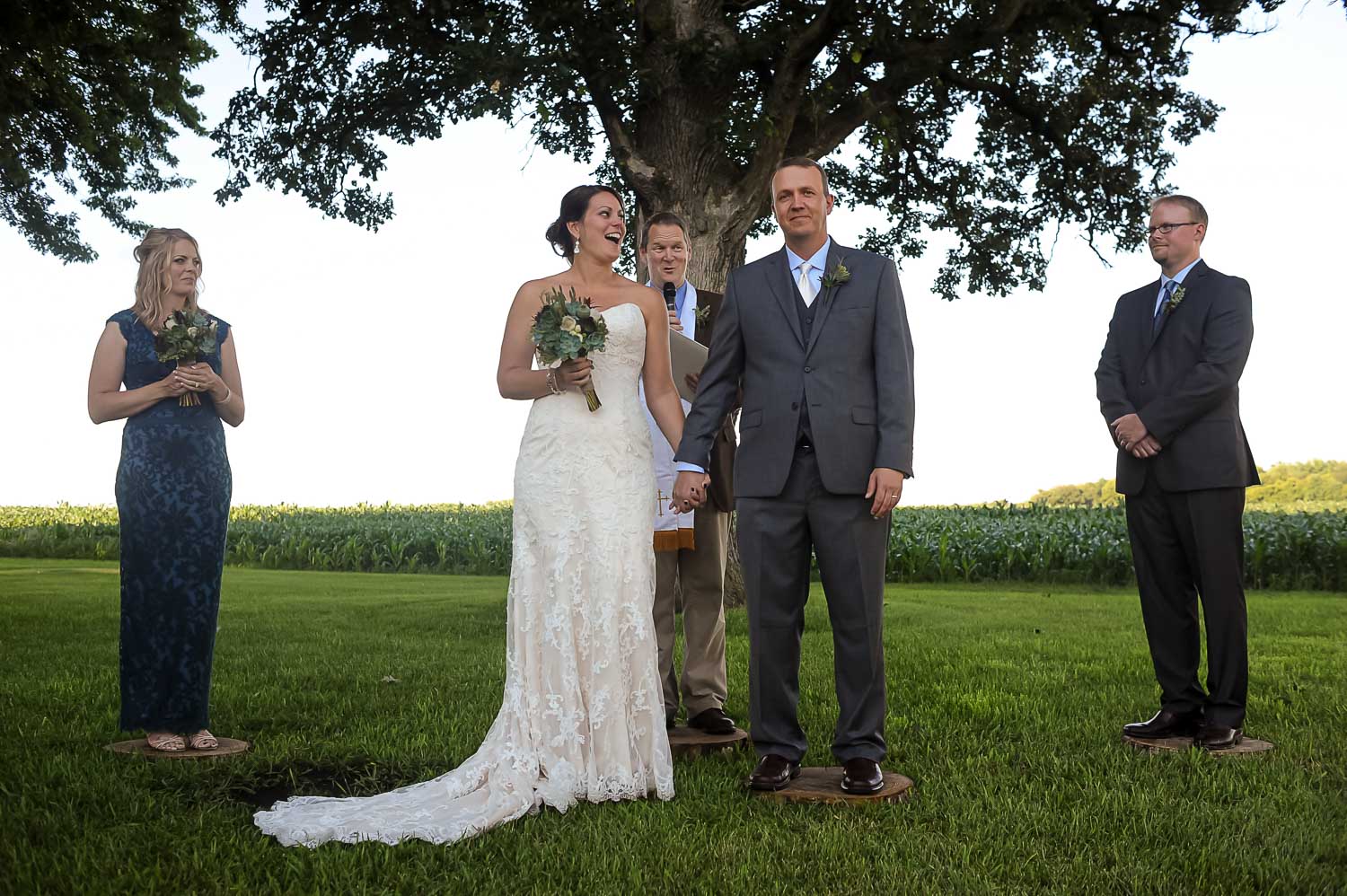 bride and groom laughing during their ceremony at their Iowa Farm wedding