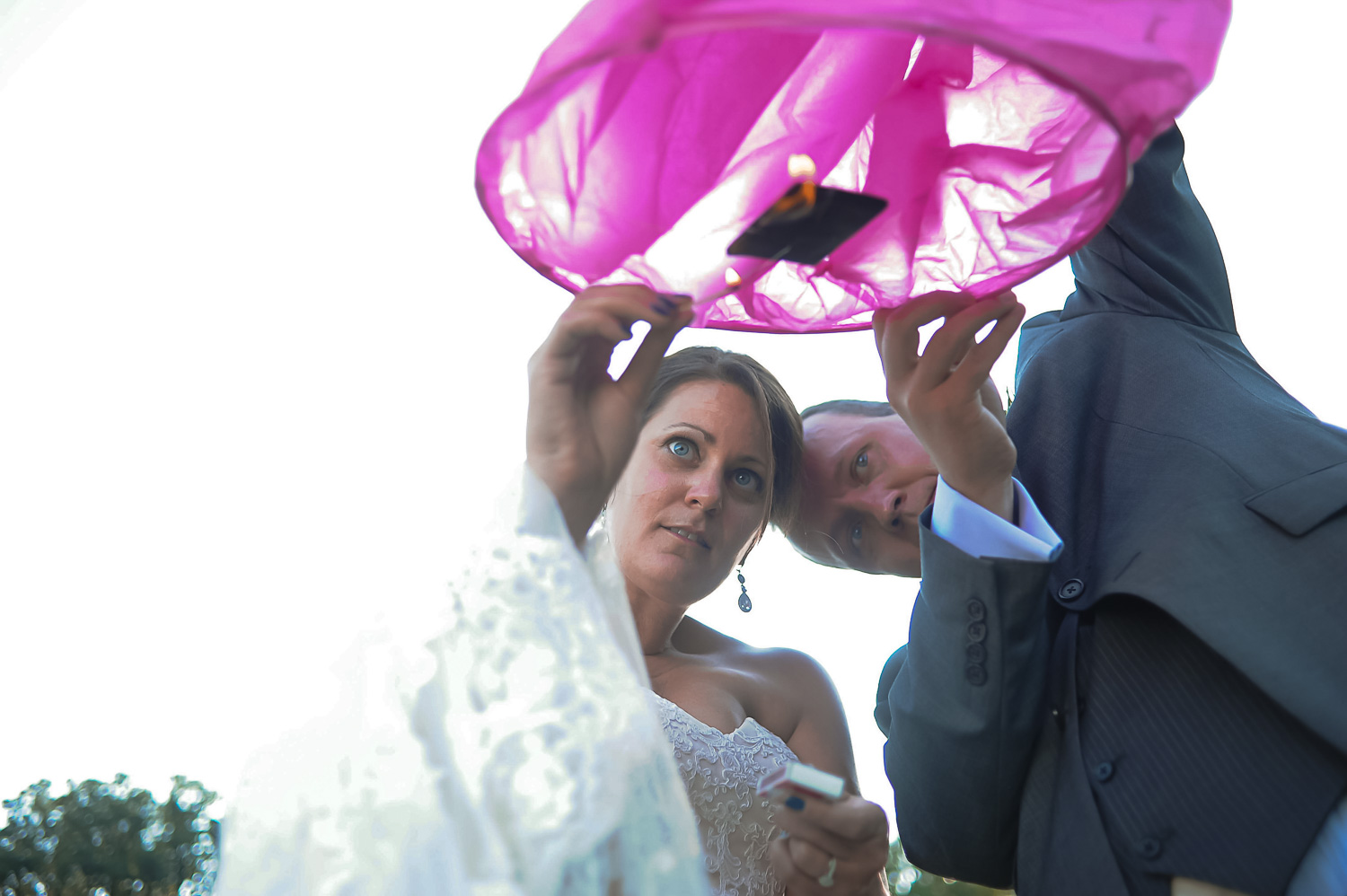 bride and groom lighting paper lanterns during their Iowa Farm wedding