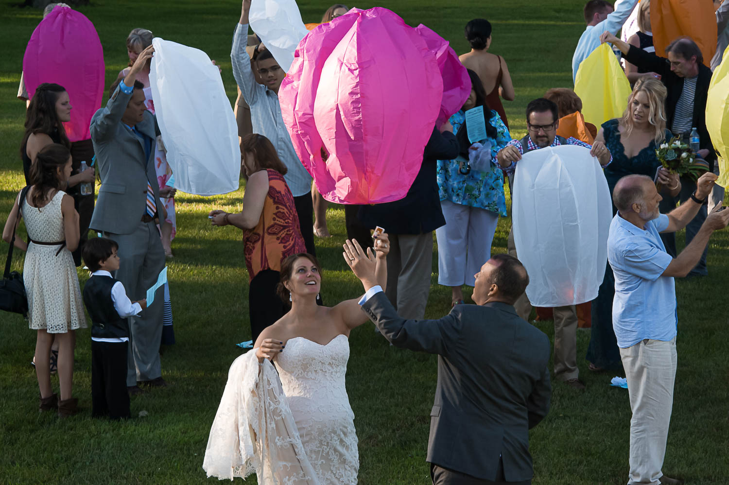 bride and groom lighting paper lanterns during their Iowa Farm wedding