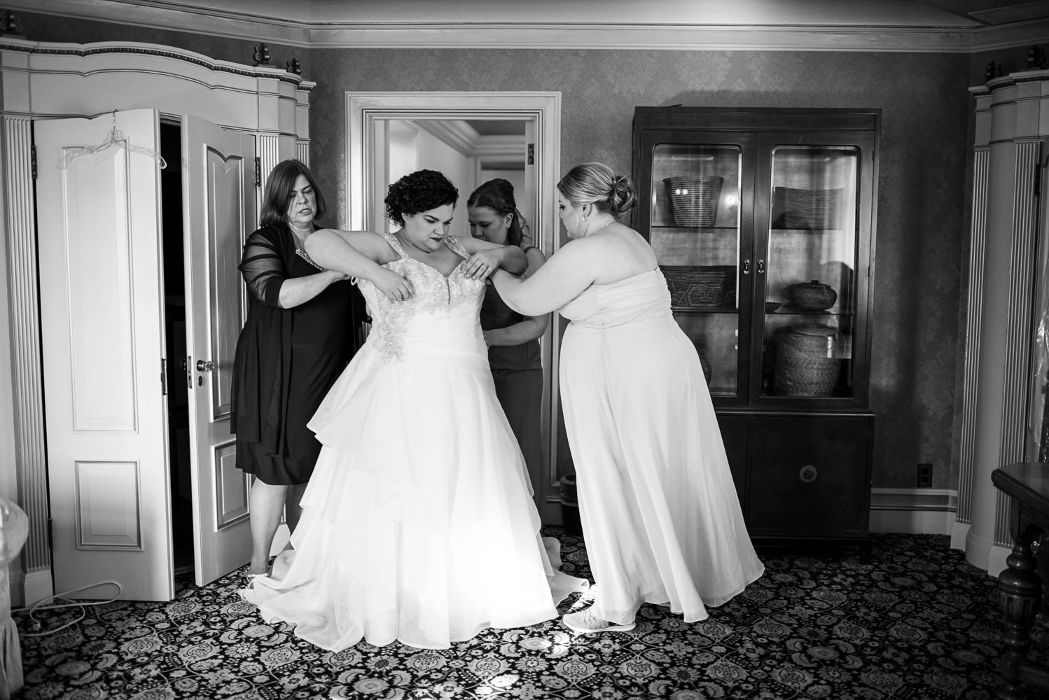 bride getting her dress on before the wedding at the St Paul College Club