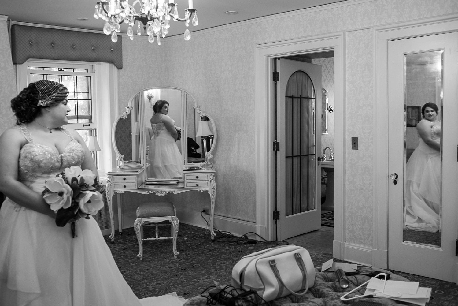 bride in the dressing room looking at herself in the mirror at the St Paul College Club