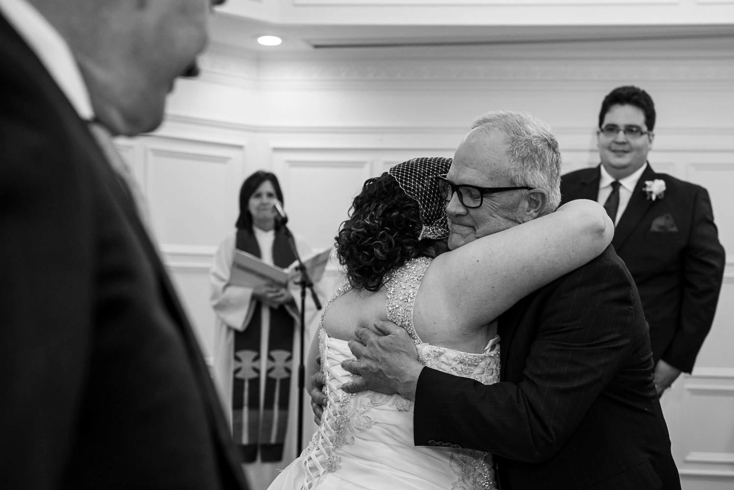 father hugging the bride at the alter before the wedding at the St Paul College Club