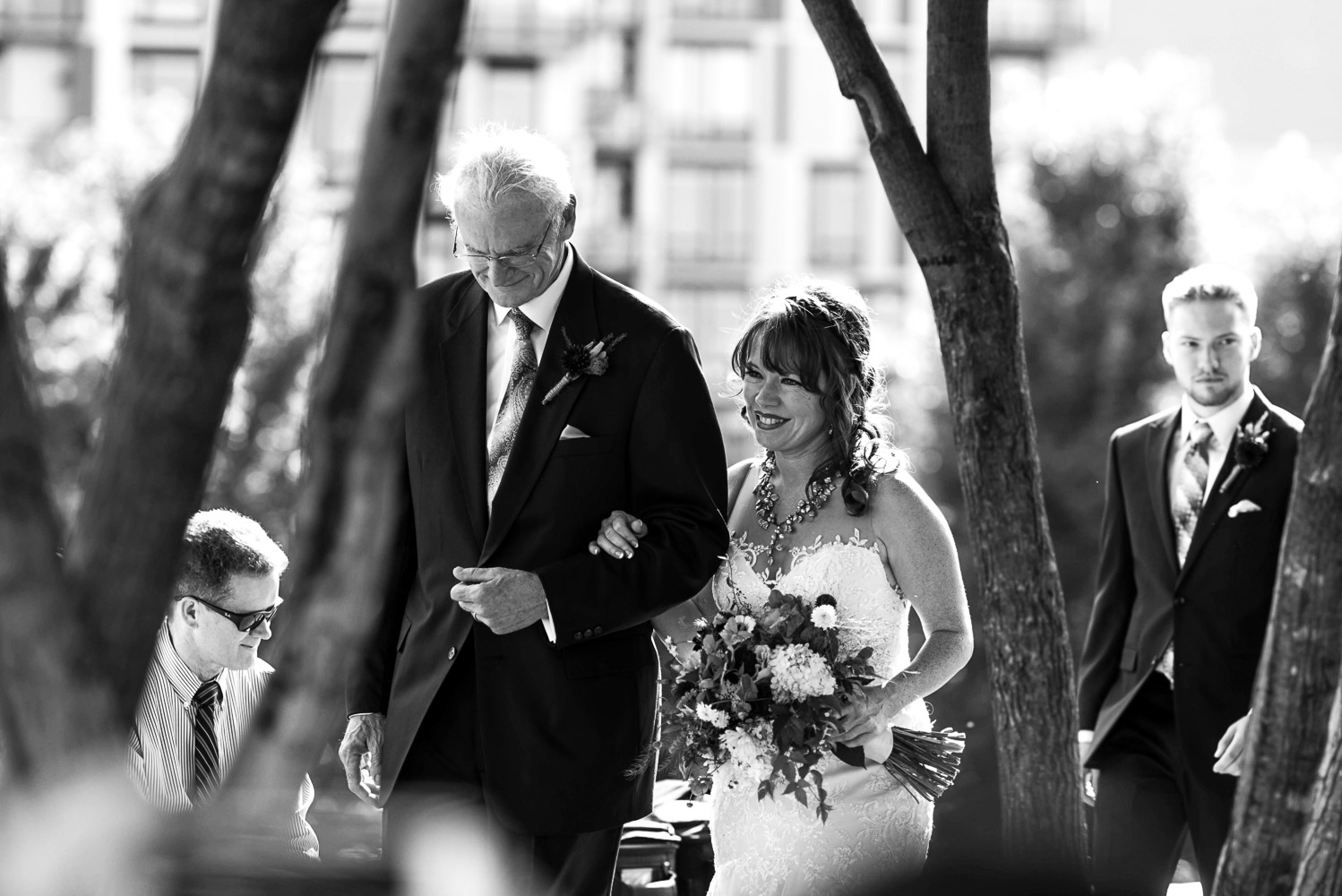 bride and her father walking to the ceremony at Gold Medal Park in Minneapolis
