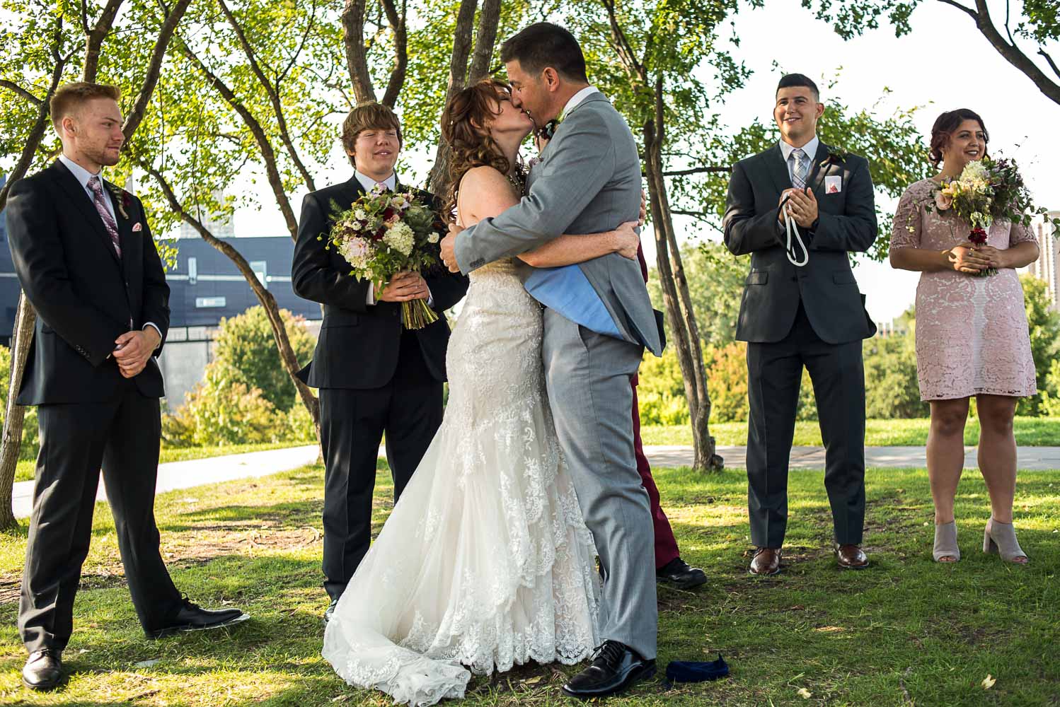 bride and groom first kiss at Gold Medal Park in Minneapolis