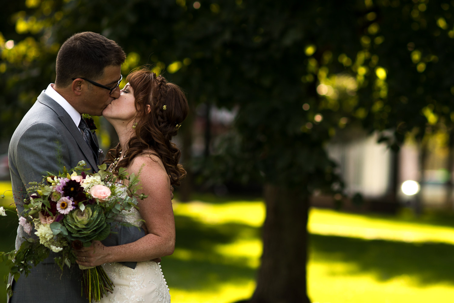 bride and groom at kissing at Gold Medal Park in Minneapolis