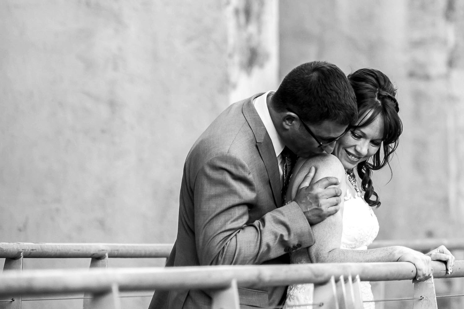 bride and groom snuggling on St Anthony Main in Minneapolis