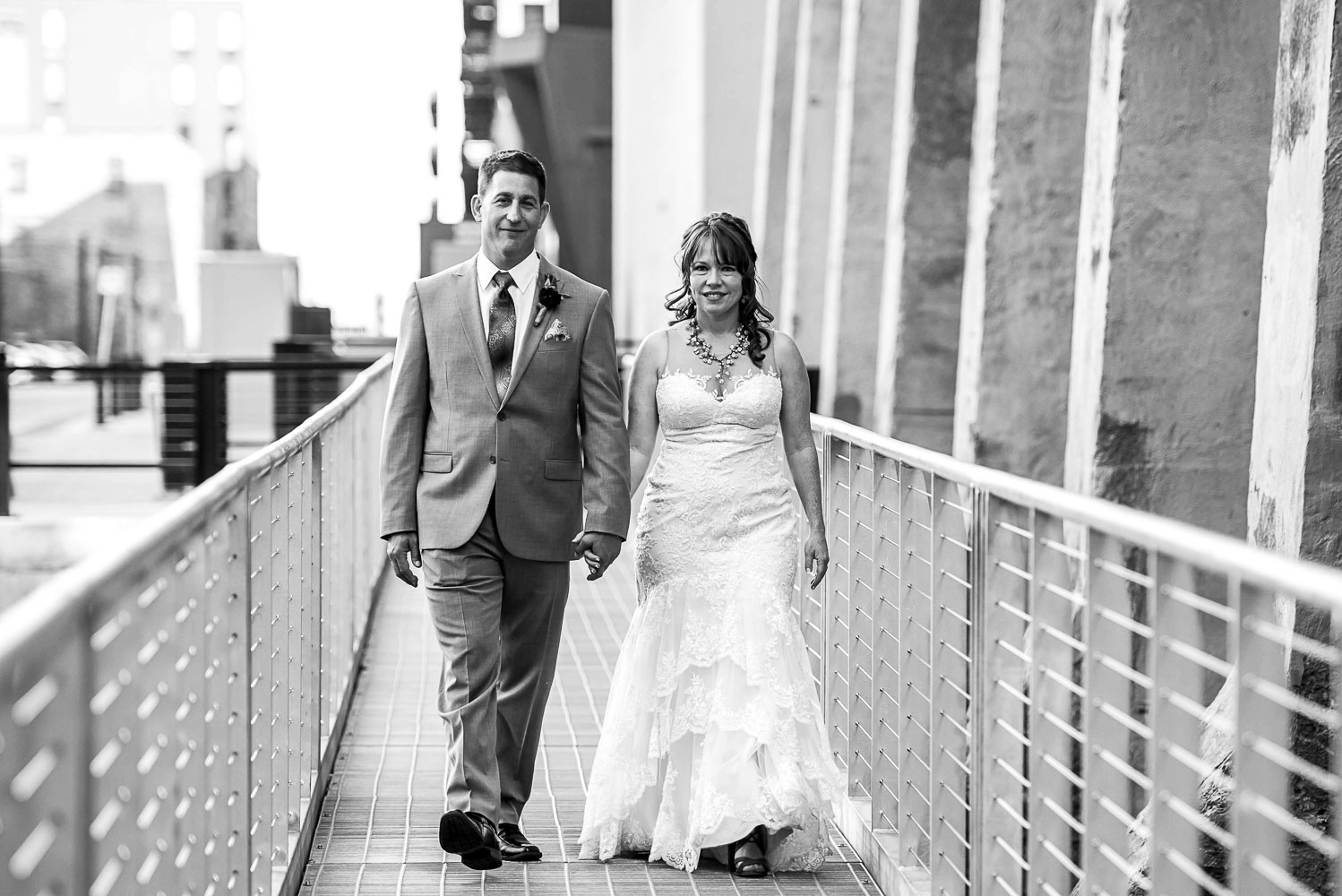 bride and groom snuggling on St Anthony Main in Minneapolis