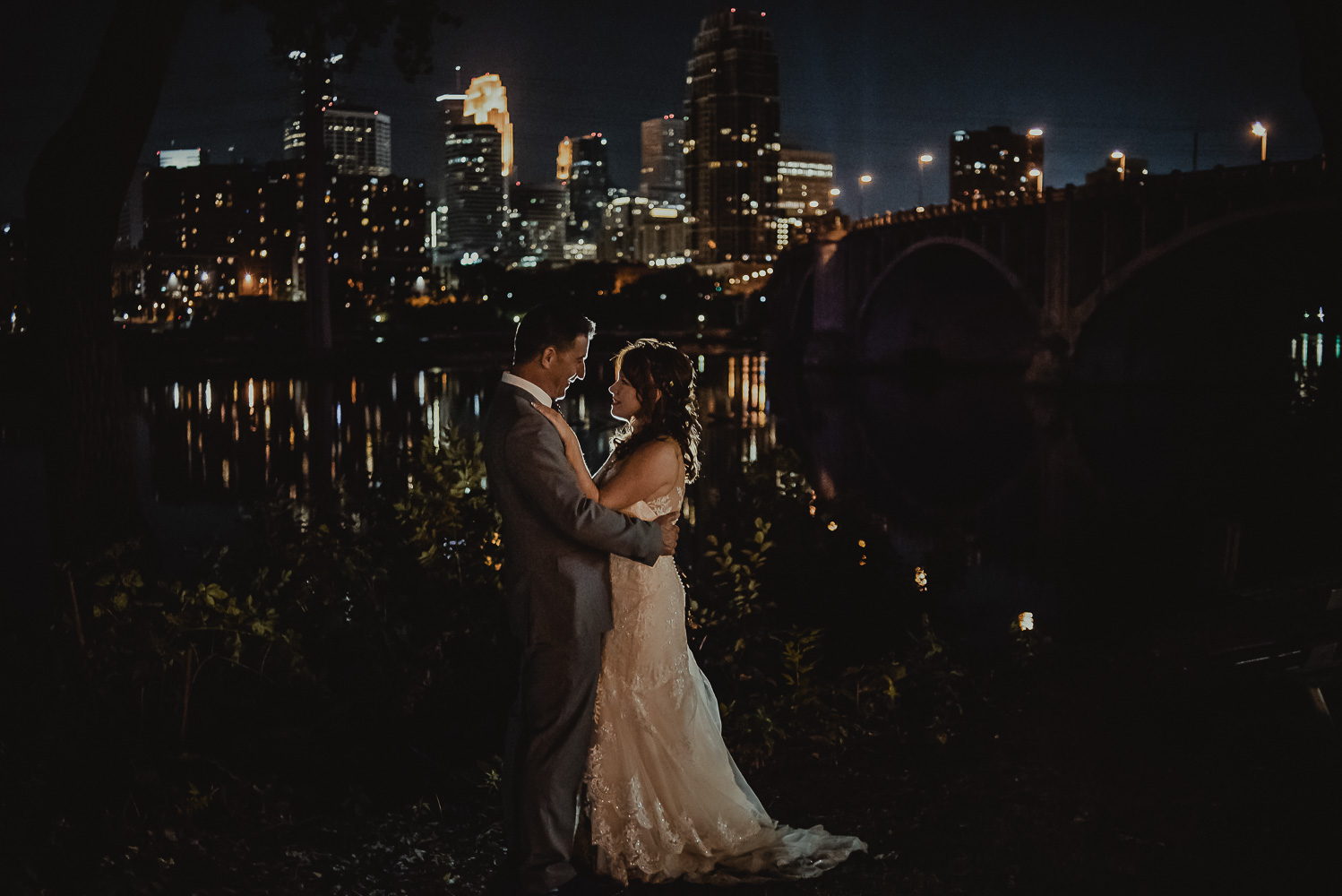 bride and groom with the city of Minneapolis in background