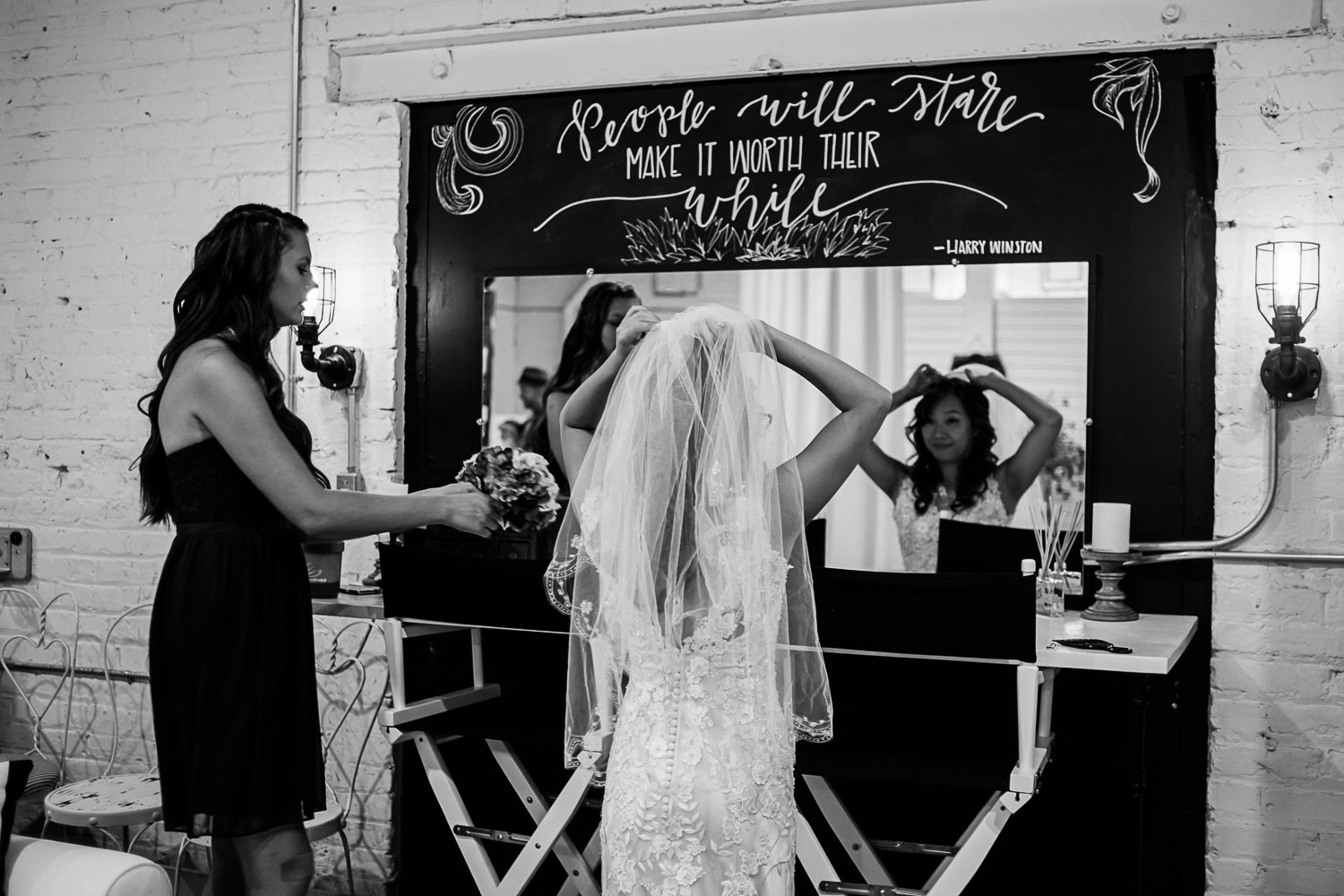 bride putting on her veil in the dressing room at Neu Neu