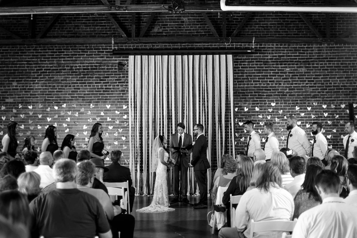bride and groom standing holding hands during their wedding ceremony in Minneapolis