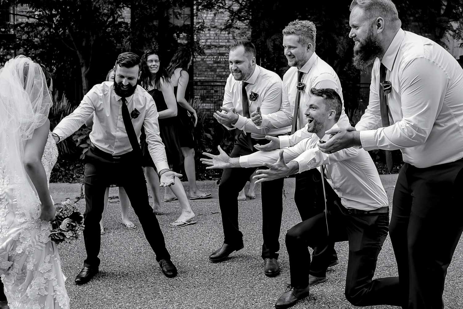 groomsmen getting ready to pick up the bride during the wedding party portraits