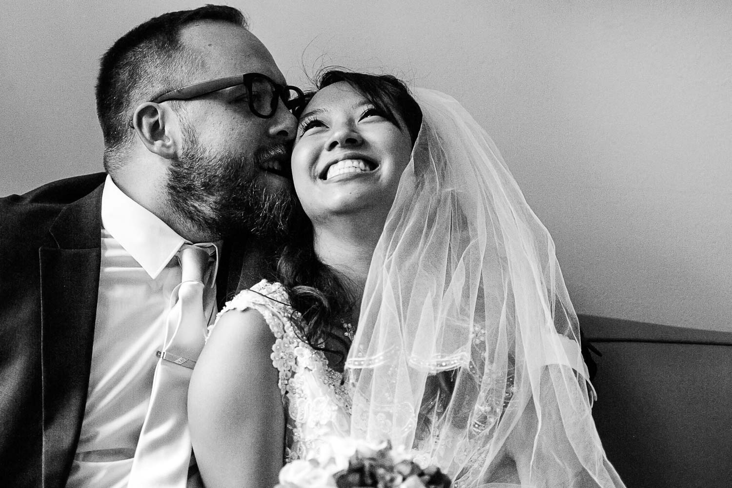 groom kissing the brides cheek