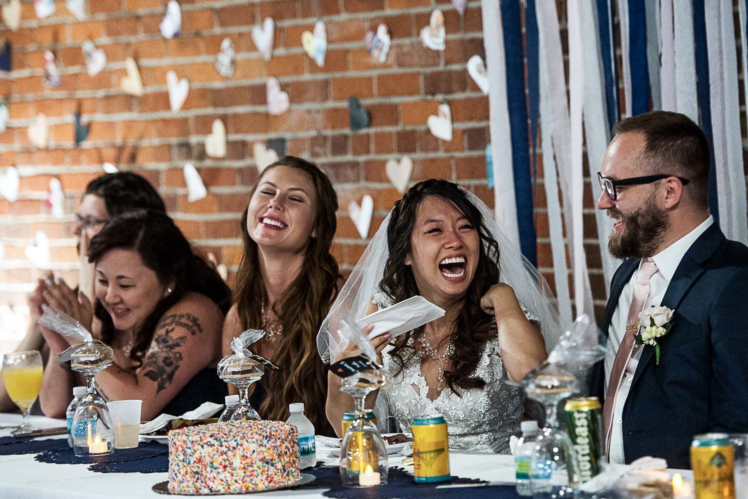 bride and groom sitting at the head table at their reception at Neu Neu