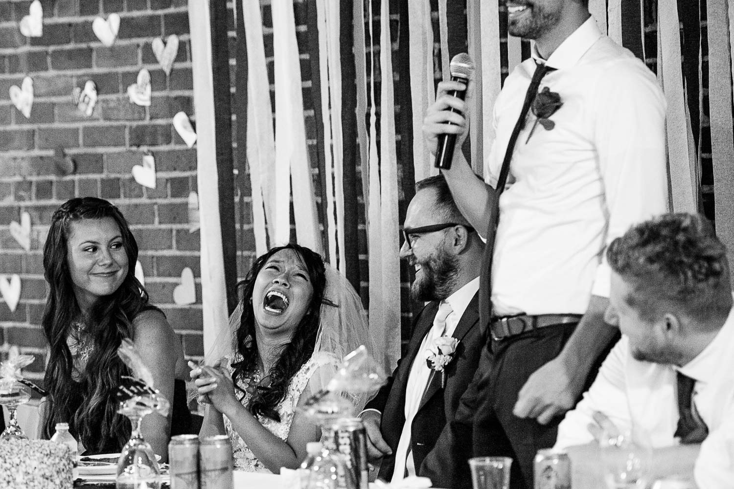 bride and groom laughing during the speeches at their Minneapolis North Loop