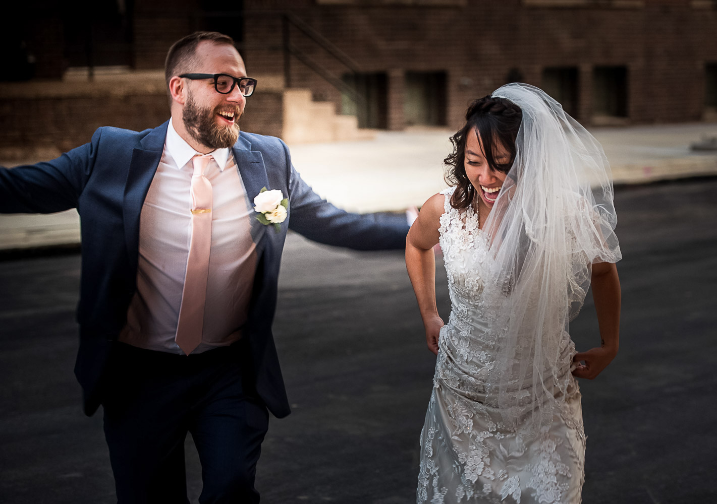 bride and groom walking together in the industrial area of the North Loop