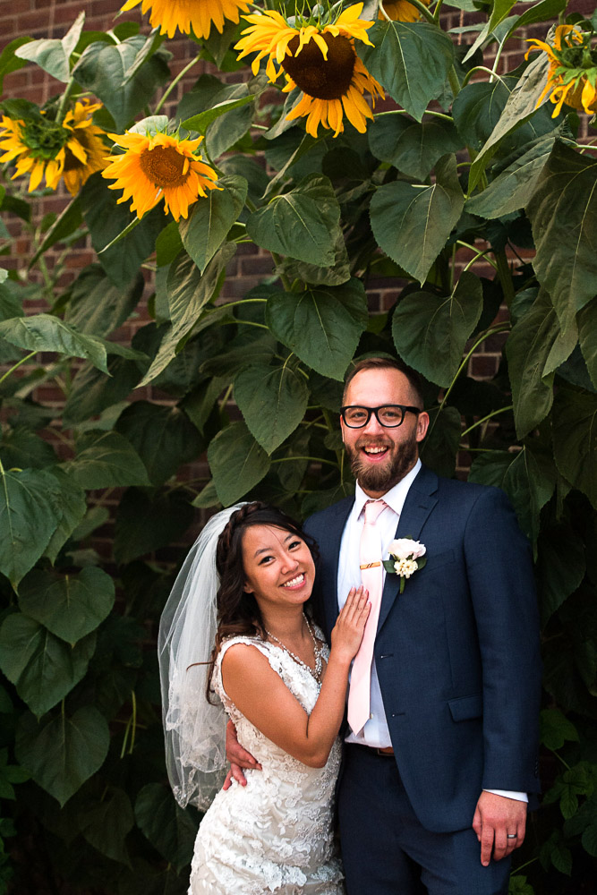 bride and groom portrait in front of sunflowers in Minneapolis