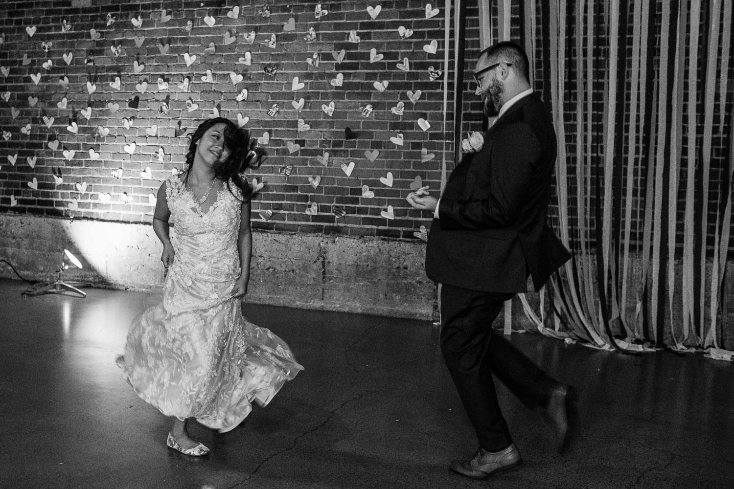 bride and groom dancing together at their industrial venue in Minneapolis