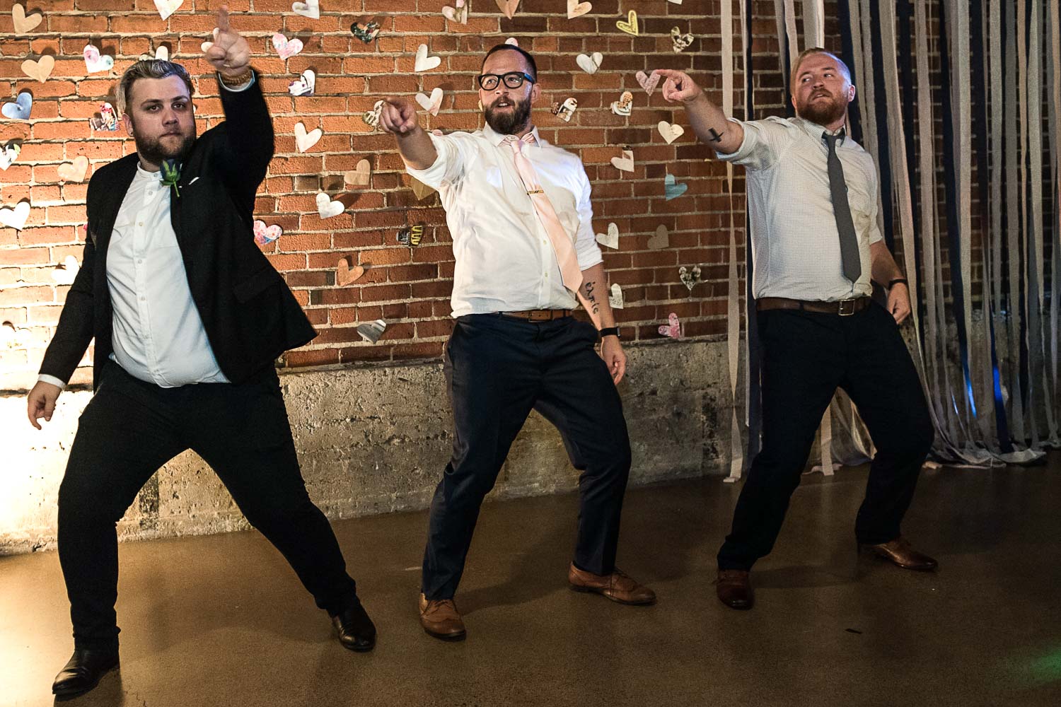 groom dancing with the groomsmen to YMCA