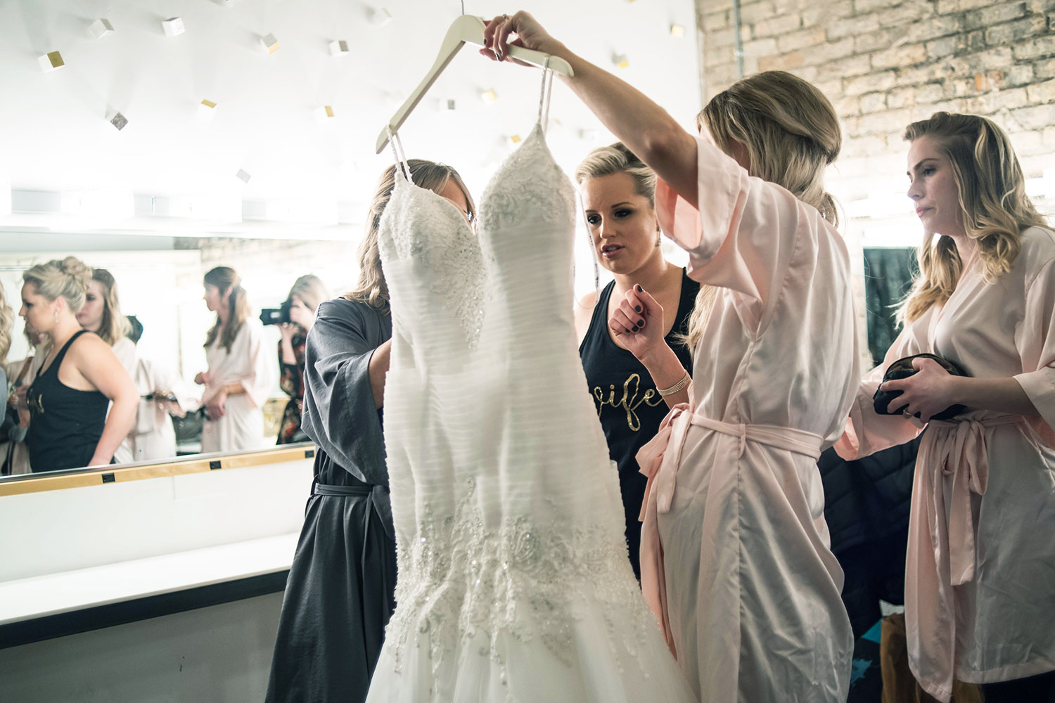 bride getting ready to put on her wedding dress in the Aria dressing room