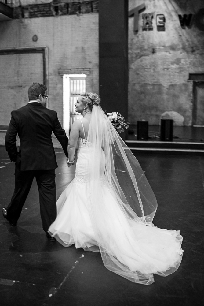 bride and groom walking together after their wedding ceremony at Aria in Minneapolis