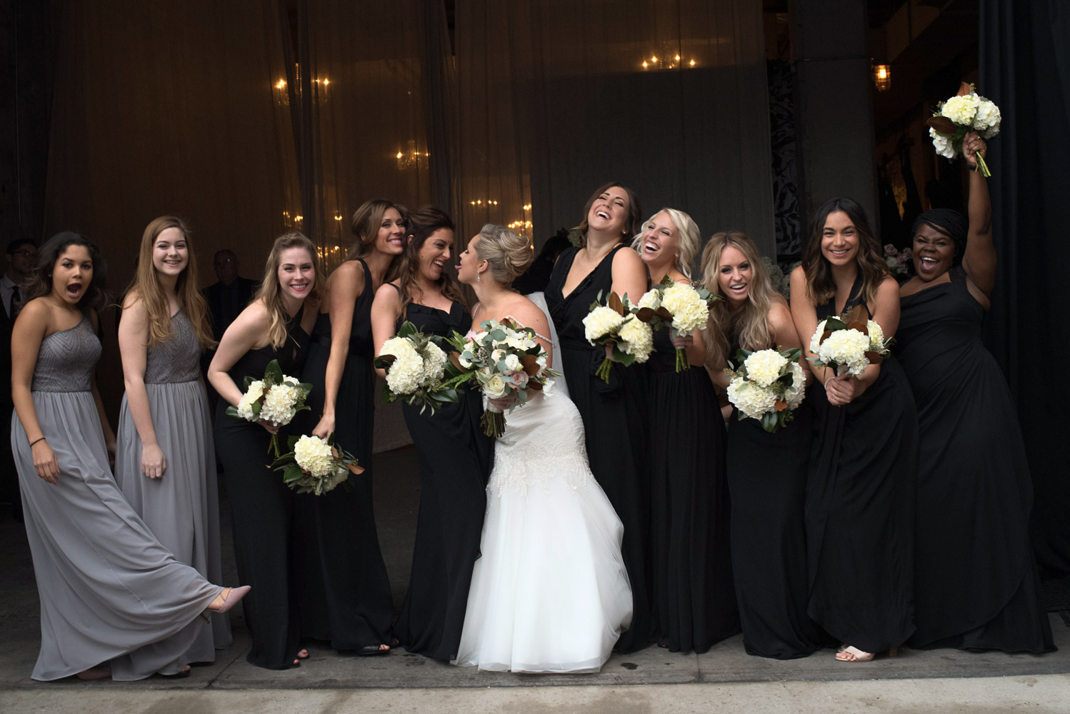 bride and bridesmaids holding their flowers and laughing at Aria Minneapolis