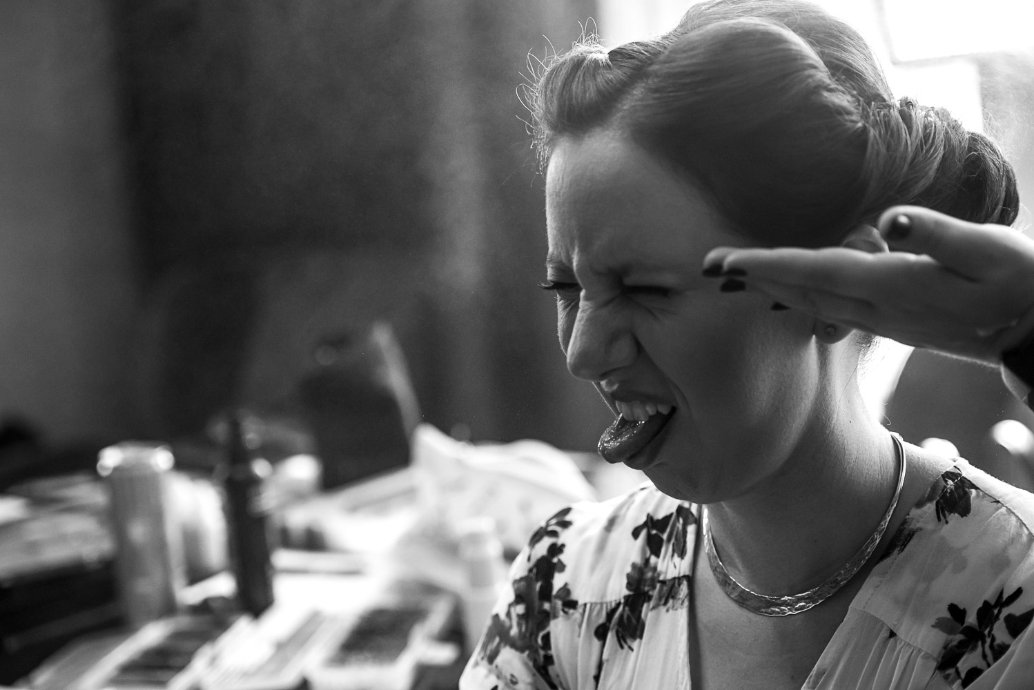 bride getting her hair sprayed