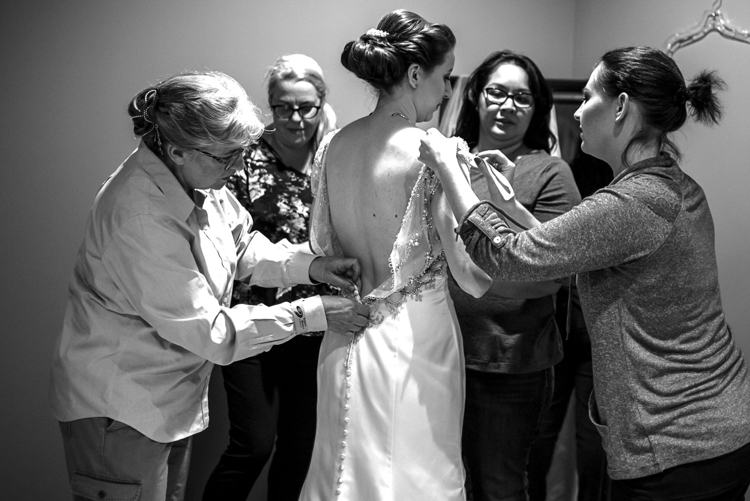 bride getting into her wedding dress at the St Paul Science Museum