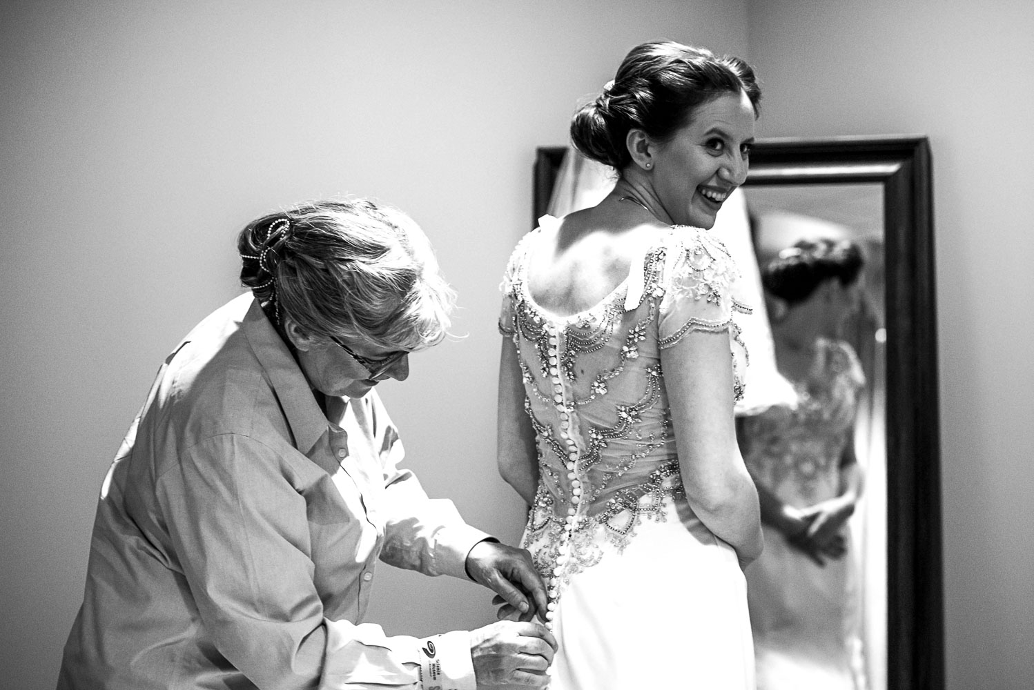 mother buttoning the brides dress in St Paul at the Science Museum
