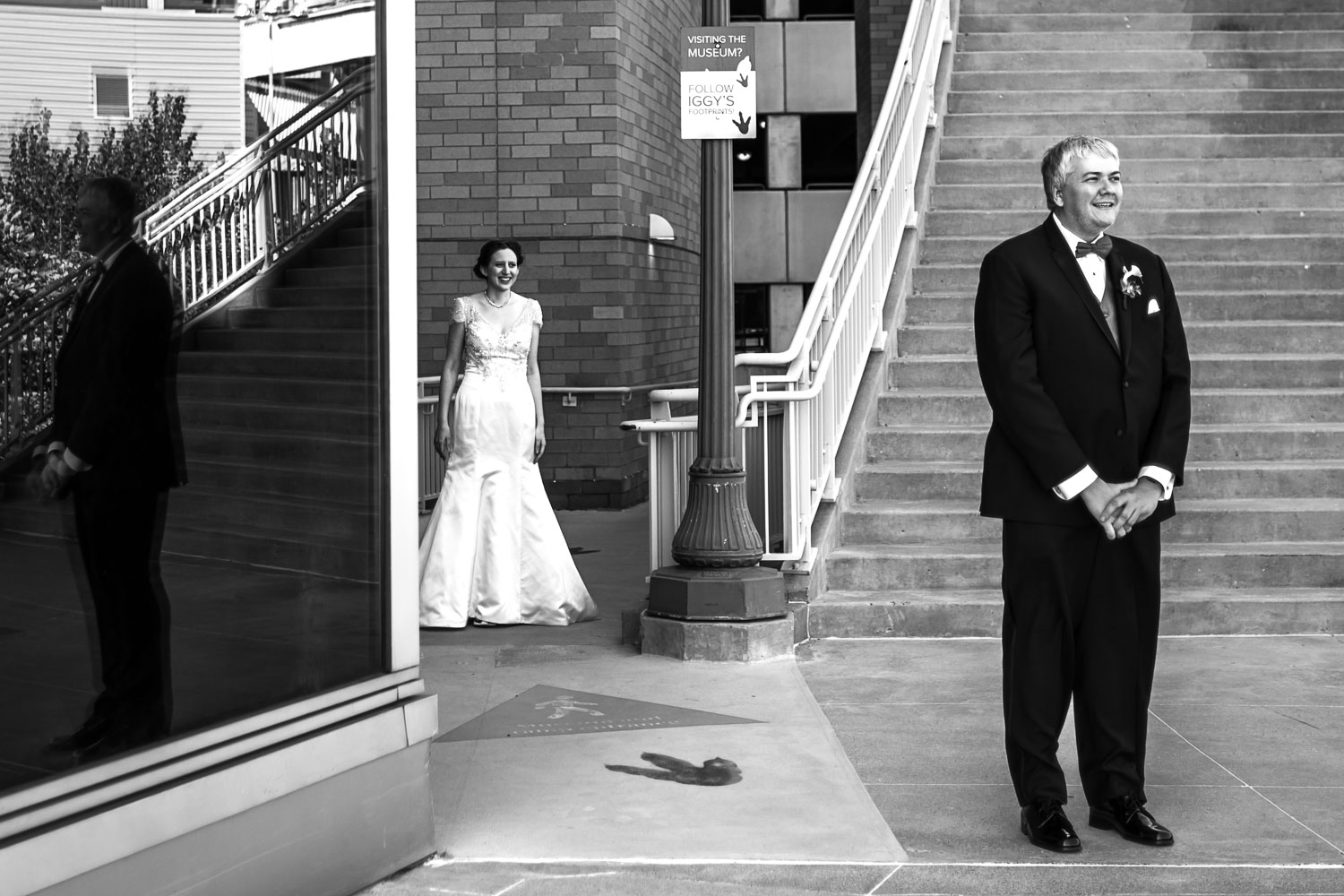 groom waiting for his bride for their first look at the Minnesota Science Museum