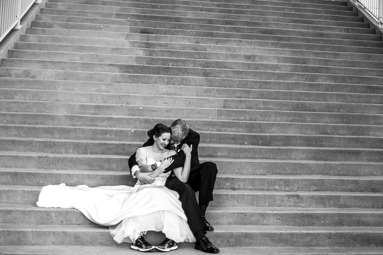 bride and groom hugging on the stairs at the Minnesota Science Museum
