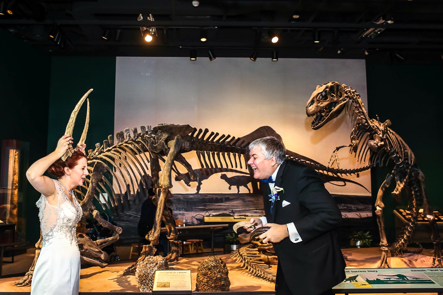 bride and groom playing with dinosaur bones at the Science Museum