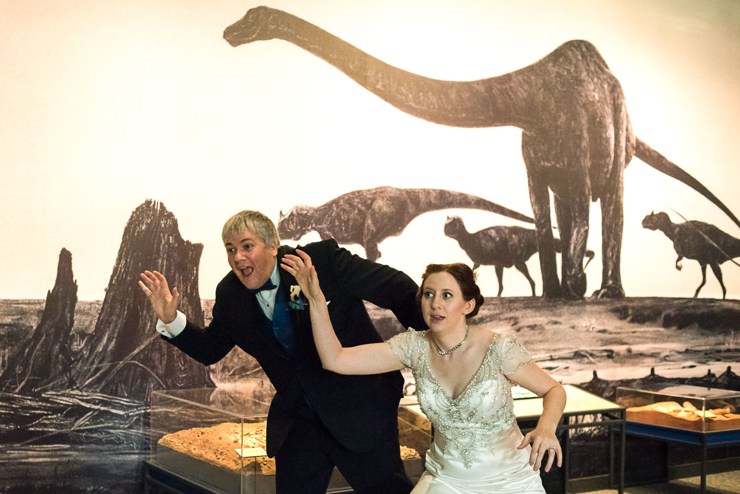 bride and groom playing with dinosaur bones at the Science Museum