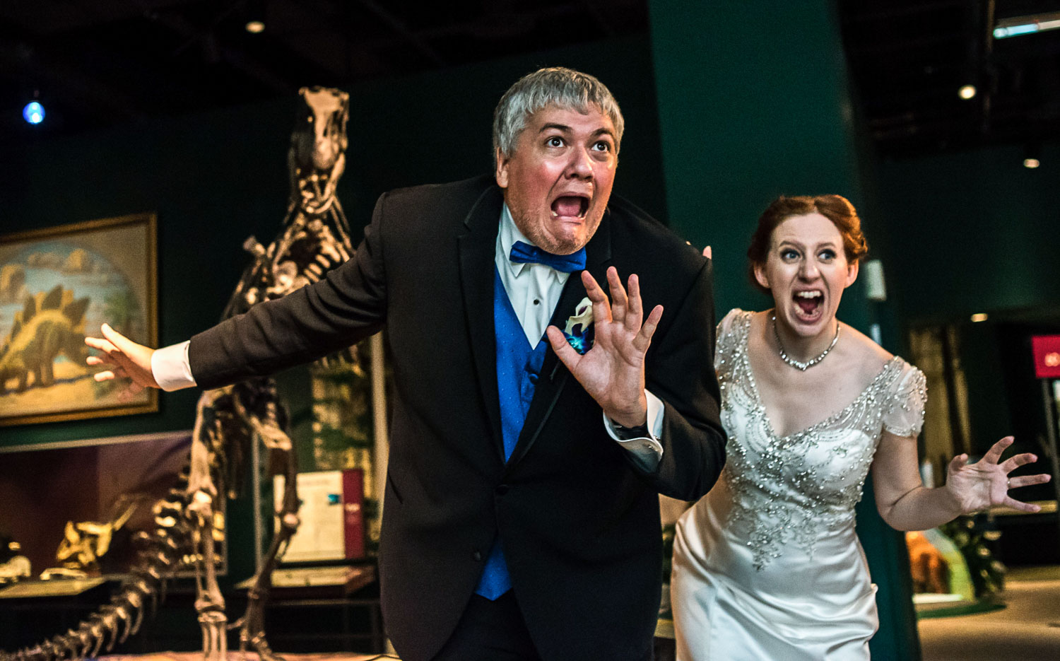 bride and groom with the dinosaur exhibit at the St Paul Science Museum 