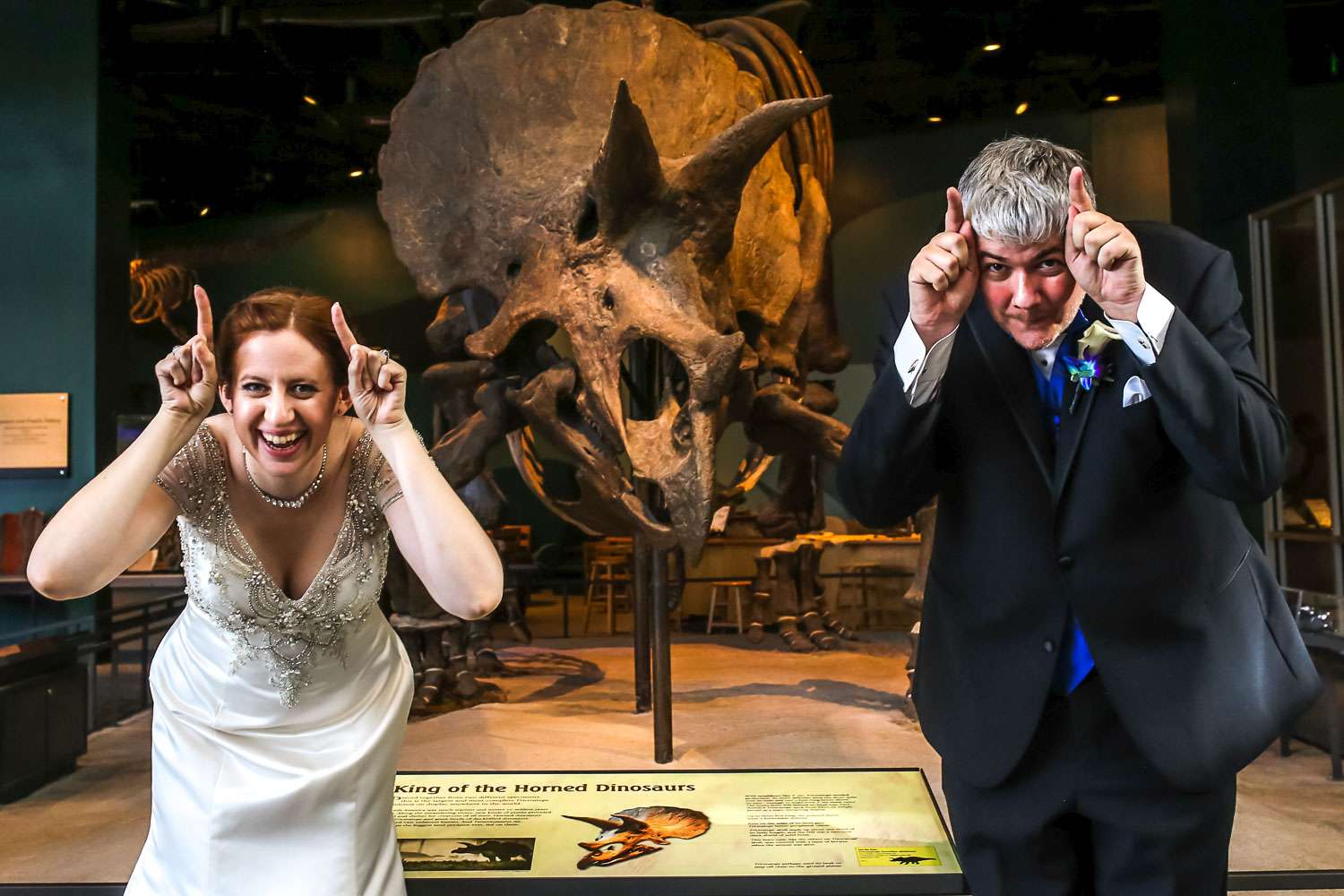 bride and groom with the dinosaur exhibit at the St Paul Science Museum 