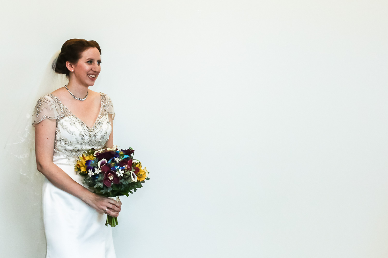 bride standing with her bouquet ready to walk down the aisle at the Science Museum