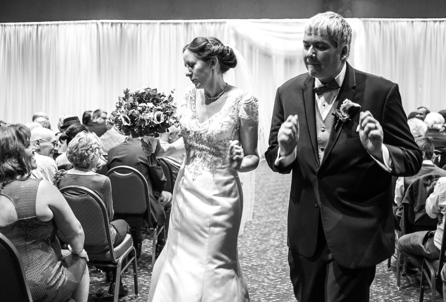 walking down the aisle after the ceremony at the Minnesota Science Museum